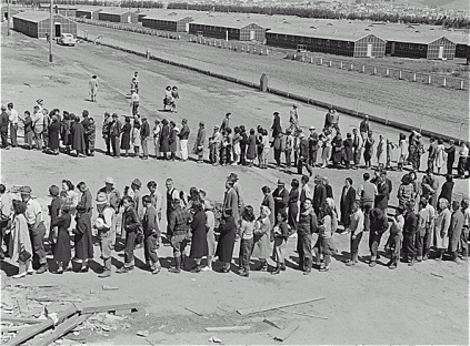 dorothea_lange_-_american_internees_in_mess_hall_line_at_tanforan_assembly_center_san_bruno_ca_april_29_1942